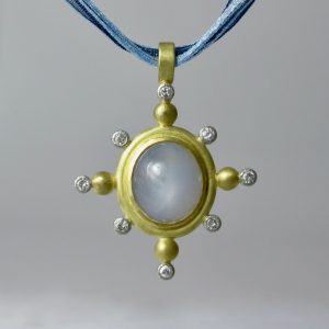 Blue star sapphire and diamond star pendant in 18 carat yellow gold