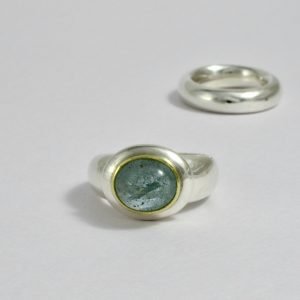 Aquamarine set in gold on heavy oval silver button and a chunky silver shank