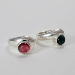 Pink and blue round tourmaline cabochons in polished silver twist rings