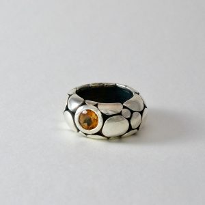 Yellow tourmaline set in heavy silver pebble ring