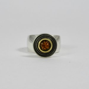 yellow tourmaline in gold setting on raised chunky silver plinth ring