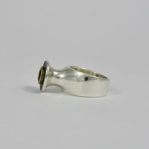 yellow tourmaline in gold setting on raised chunky silver plinth ring